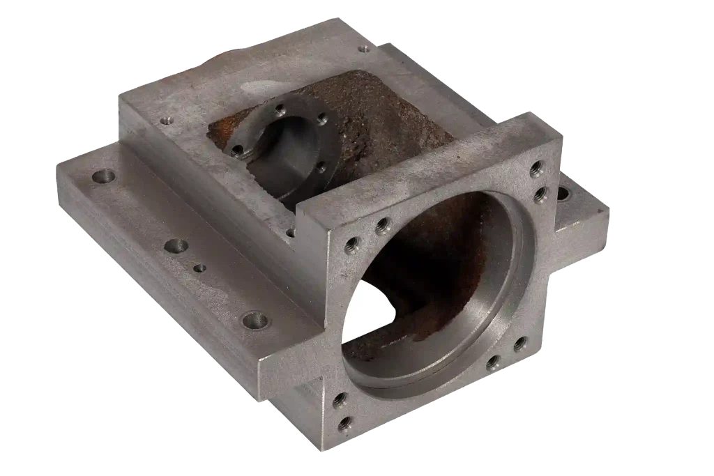 Sand cast machinery housing with internal cavity and machined openings