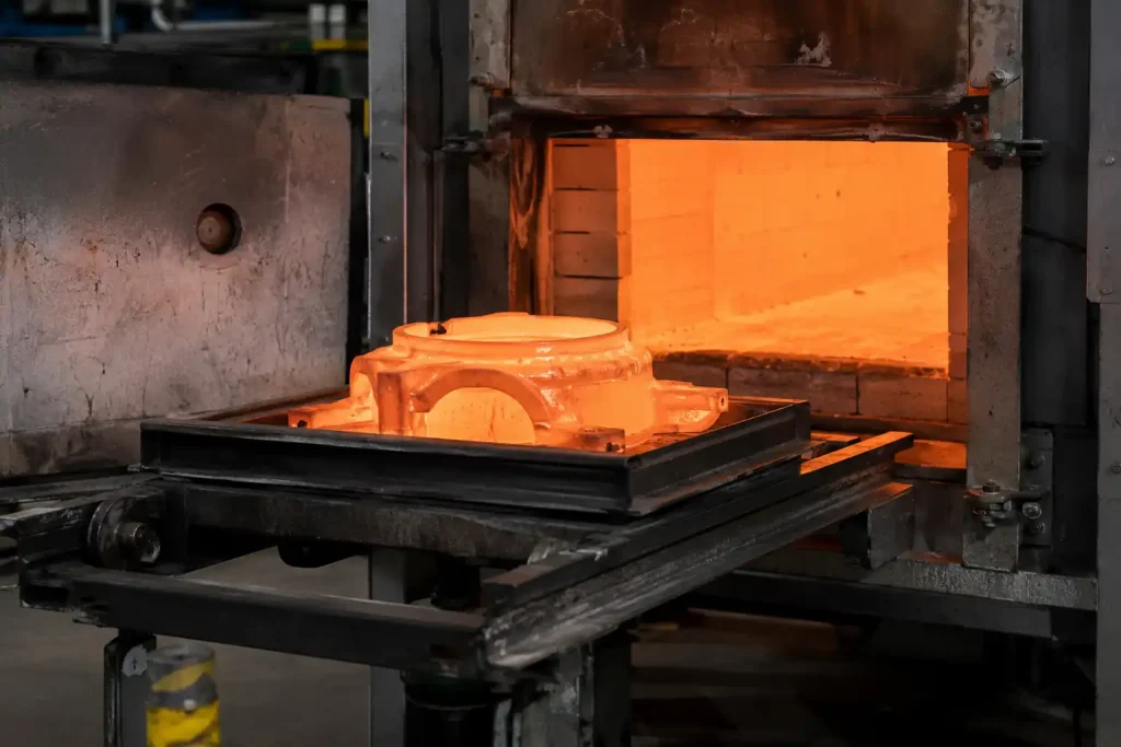 Post-casting heat treatment process with a heated metal casting leaving an industrial furnace