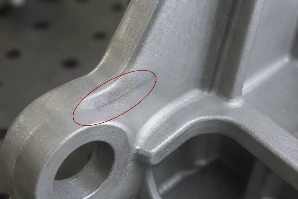 Close-up of a cold shut defect on an aluminum die casting part