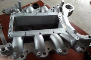 Gravity cast aluminum housing with internal cavity and machined features