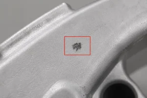 Oxide inclusion defect on low-pressure die cast aluminum surface