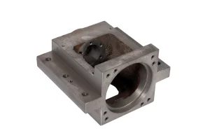 Machined cast iron housing with drilled mounting holes and rough internal casting surface