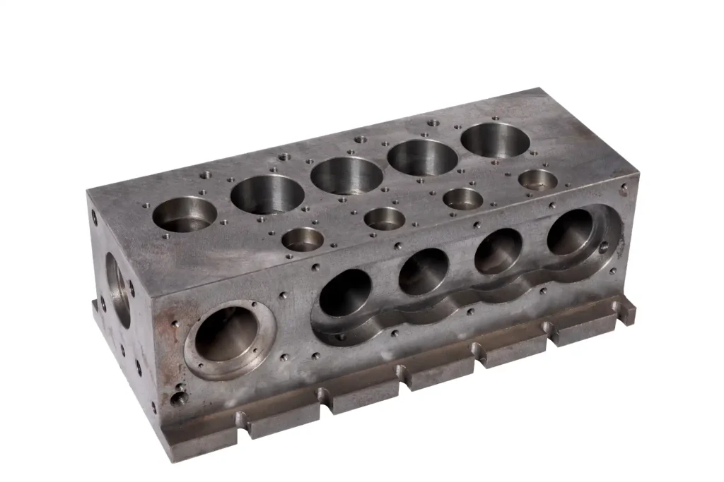 Side view of cast iron valve manifold block with machined ports