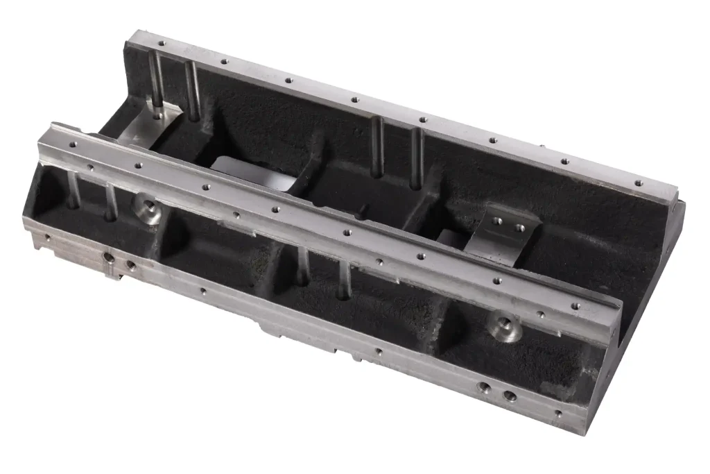 Industrial machine base frame with machined mounting surfaces and reinforcement ribs
