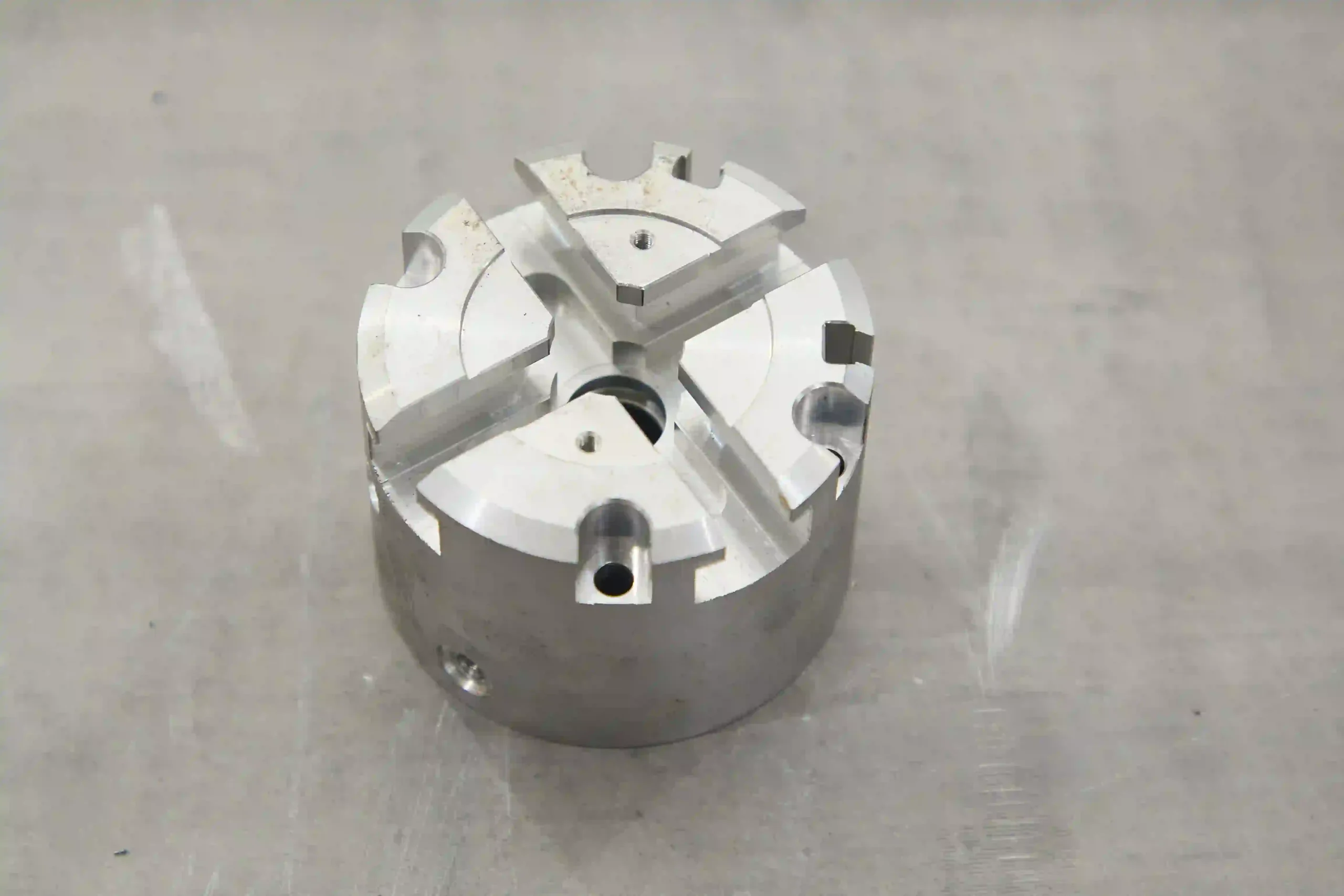 Compact magnesium alloy precision housing with machined holes and mounting features.